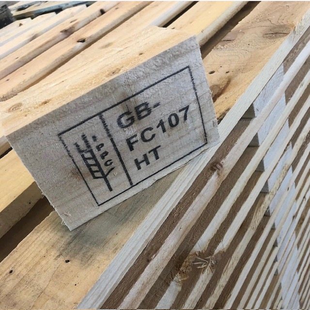 Close-up of the GB FC 107 IPPC heat treatment mark on a wooden pallet